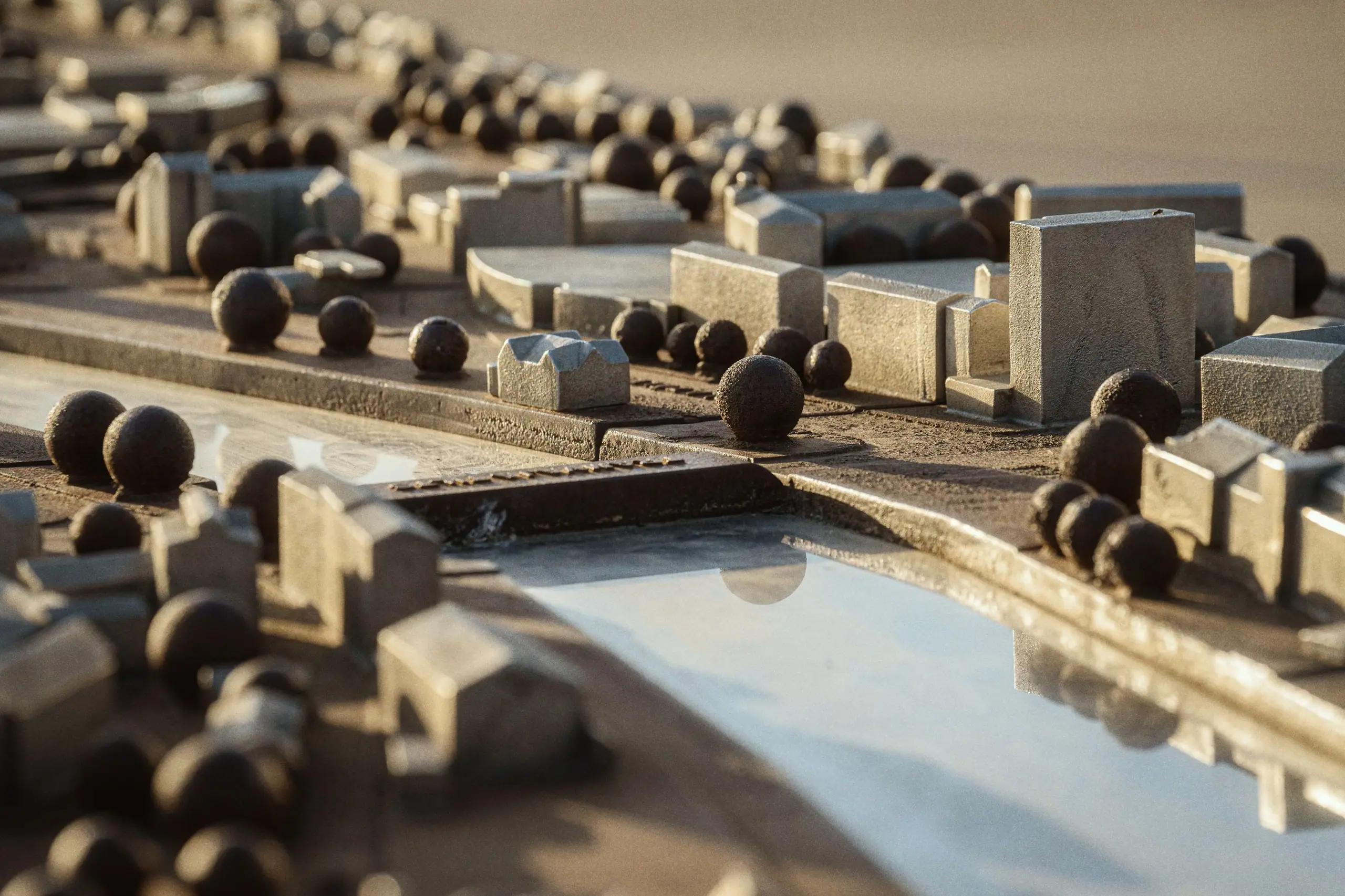 A physical study model of the street, with houses and trees in card and timber