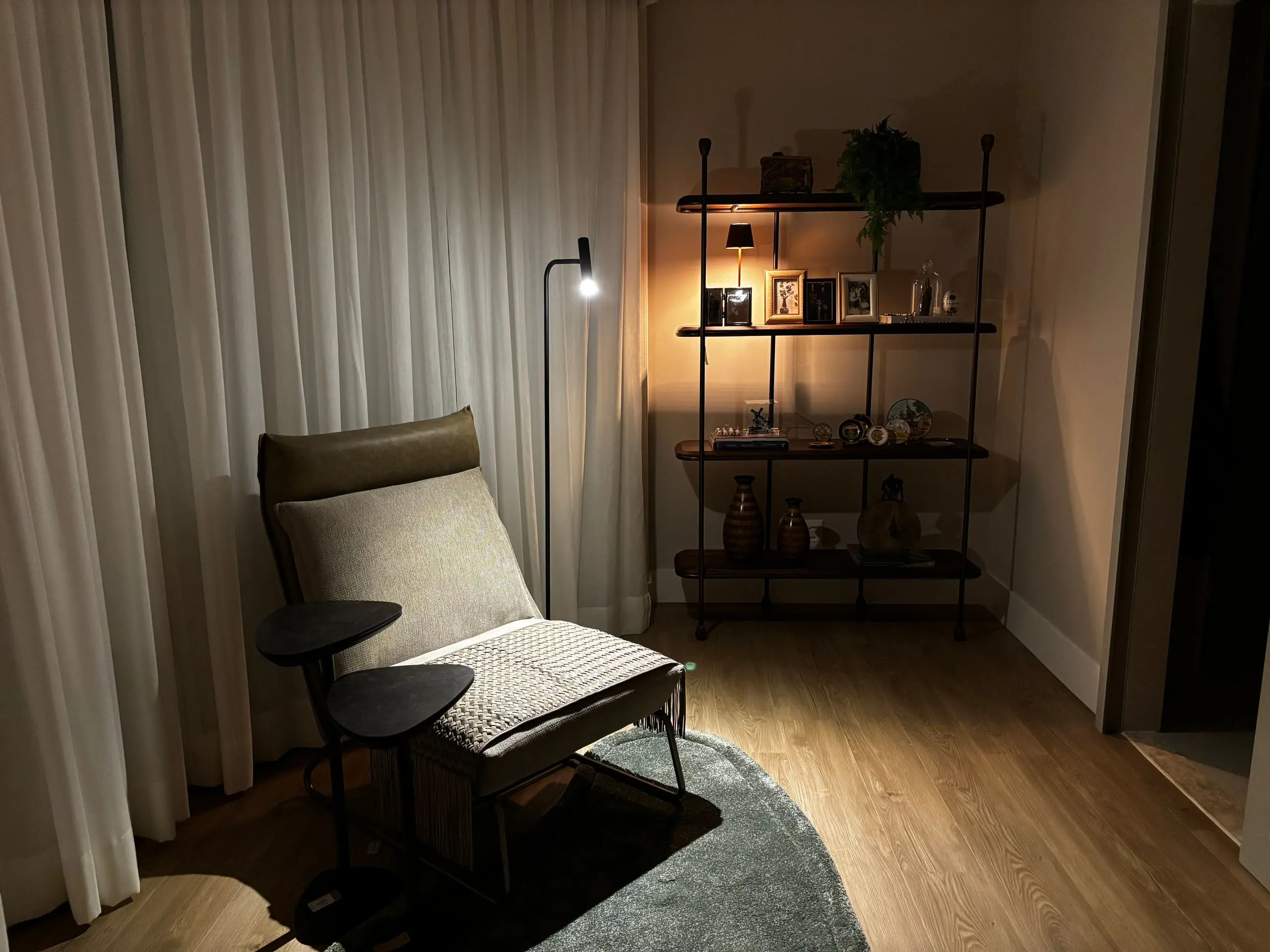 Reading corner with a lounge chair, lamp and open shelving