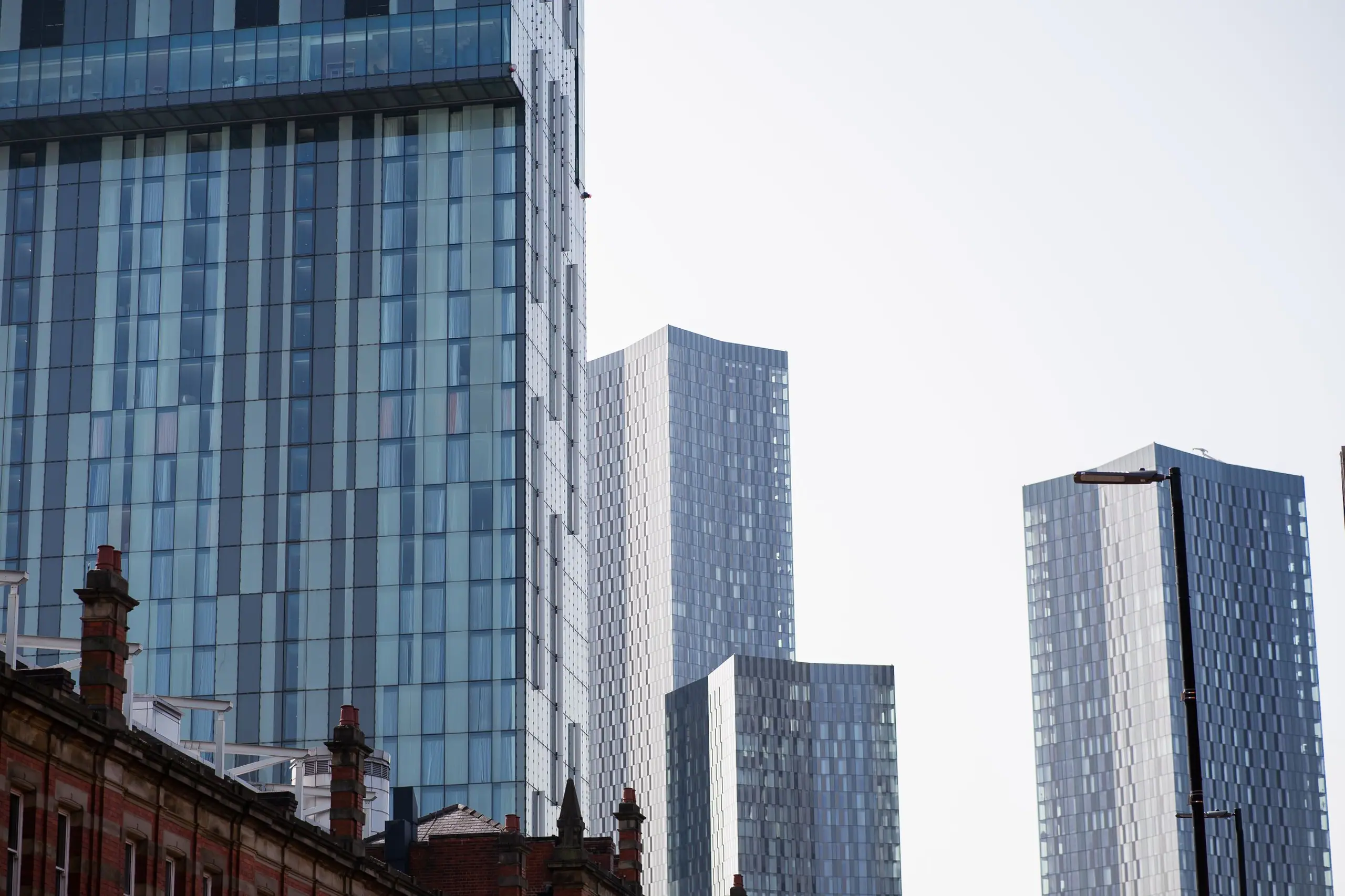 Glass residential towers rising behind Victorian rooftops
